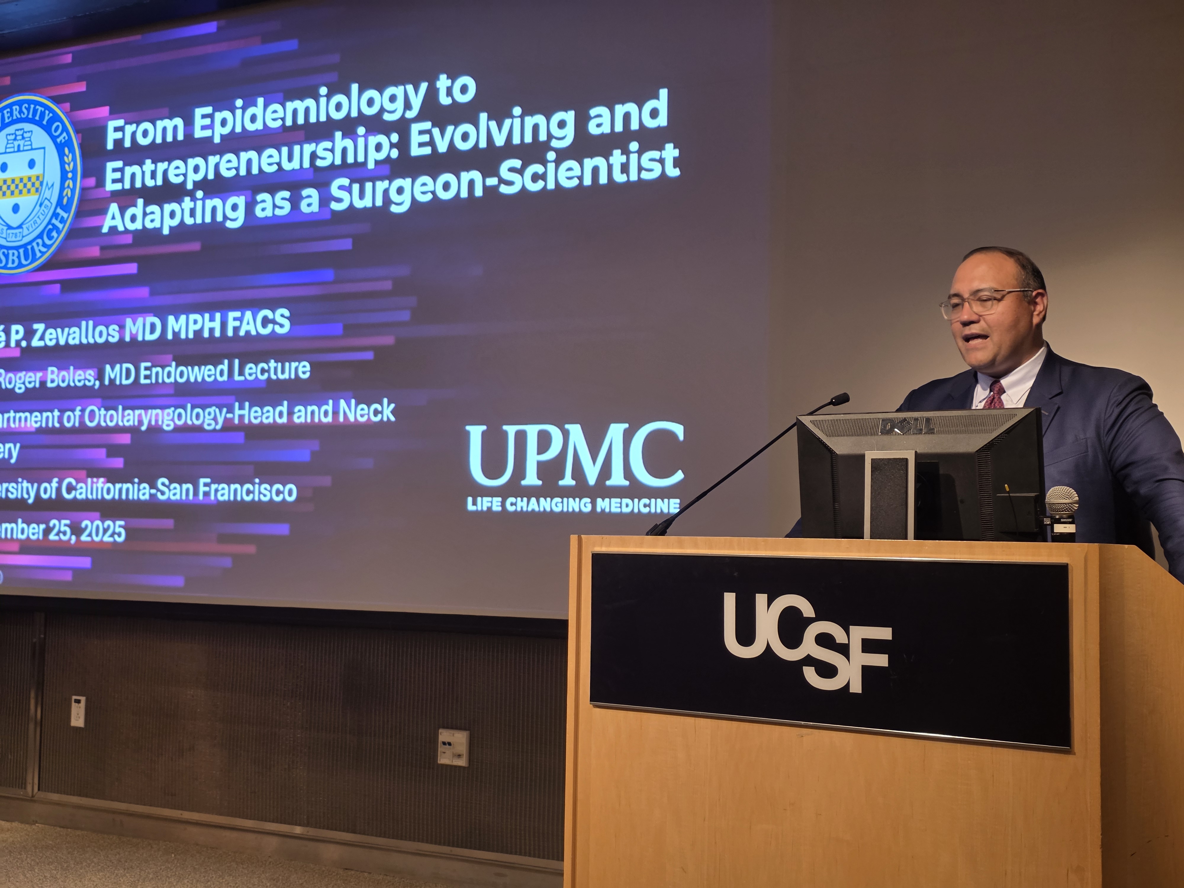 Dr. Zevallos stands at a podium that reads UCSF on the front.