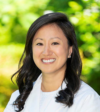 Headshot of Dr. Grace Banik, female physician in a white coat