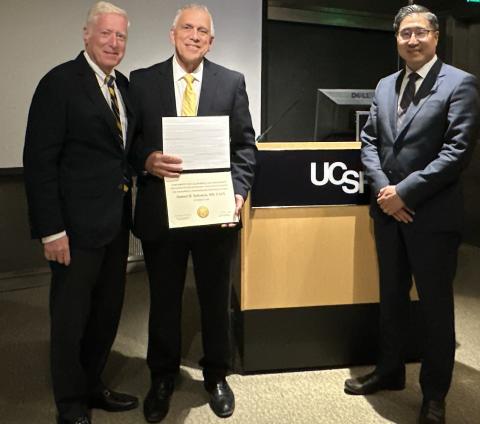 Drs. Murr, Selesnick, and Limb (l-r) in front of lecturn after lecture